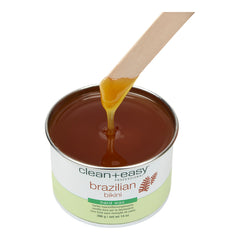 Can of clean+easy Brazilian bikini hard wax with a wooden applicator stick.