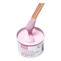 Pink soft wax with a wooden spatula in a container labeled 'C+E Lavender + Lemongrass'.