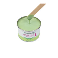 Clean + Easy BAREzilian Hard Wax with Spatula – Green hard wax tin with a wooden spatula dipped in wax for full-body hair removal.