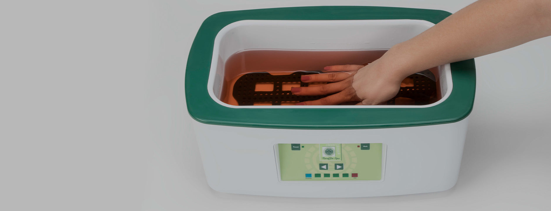 Hand dipped into a Clean + Easy paraffin wax spa machine for a soothing and hydrating treatment, leaving skin soft and rejuvenated.